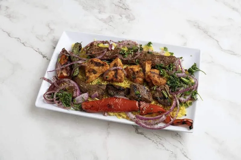 Grilled meat skewers and salad at Al Basha Halal Grill in Charlotte