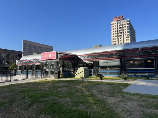 Midnight Diner’s silver exterior with Charlotte buildings behind it