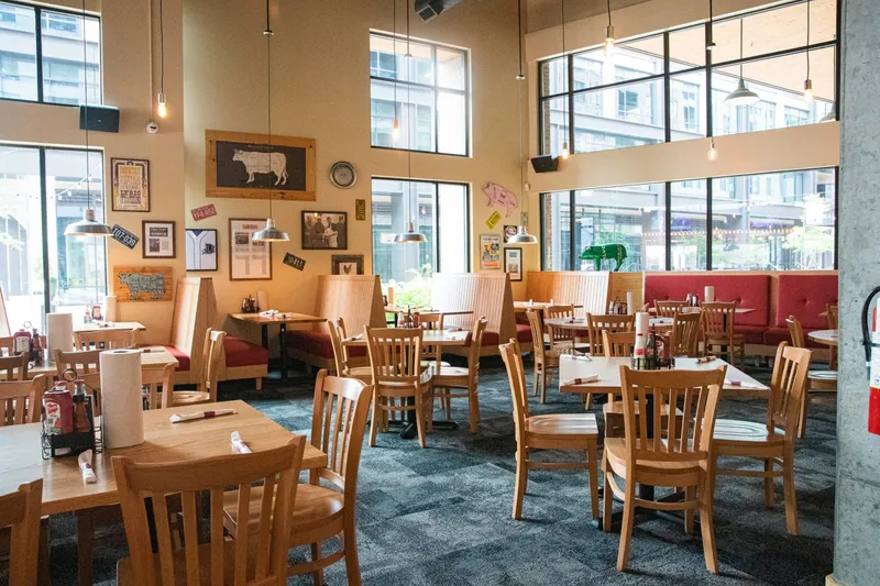 Wooden tables and wall photographs at Midwood Smokehouse in Charlotte