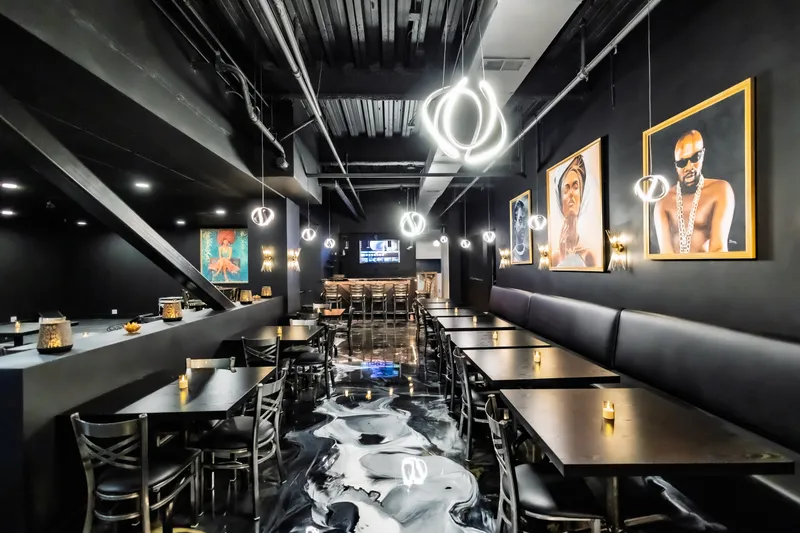 Booths and hanging lights in Sol’ Delish’s dining room in Charlotte